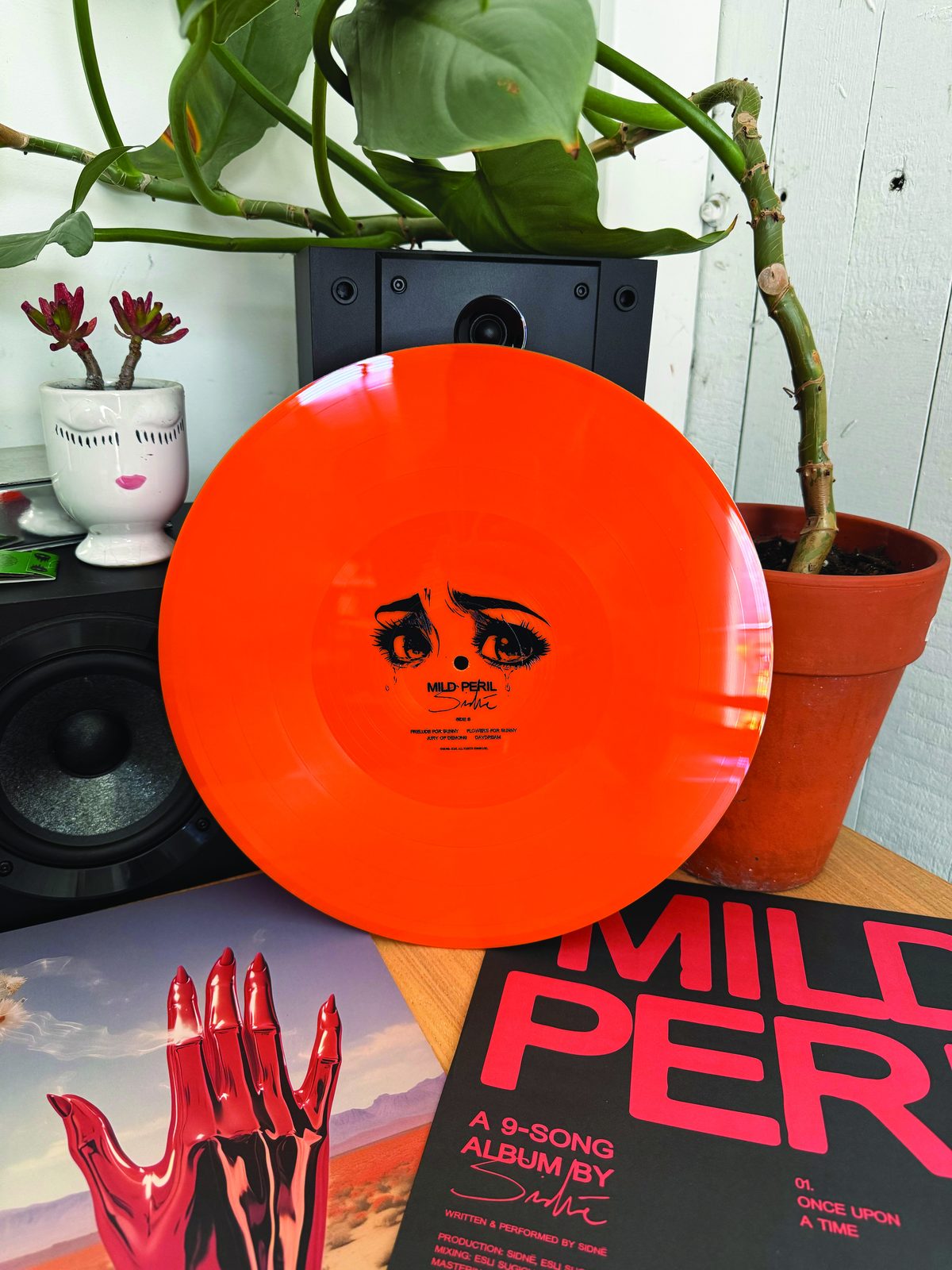 Orange record with a portrait printed in the center